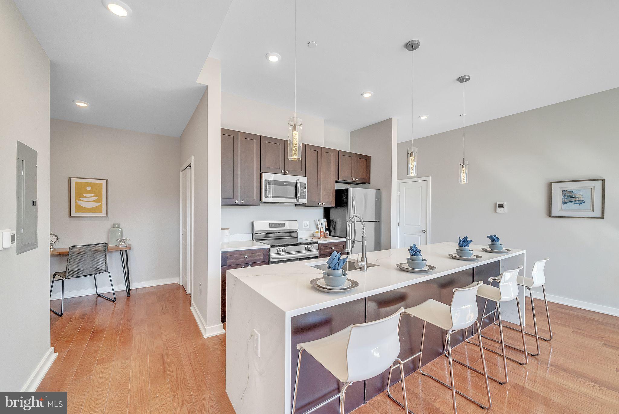 100 Forrest Avenue, Unit 204 Narberth, PA 19072 - Photo 8 of 17 a large kitchen with a table and chairs in it