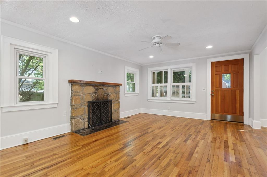 385 Sunset Drive Athens, GA 30606 - Photo 14 of 48 an empty room with wooden floor fireplace and windows