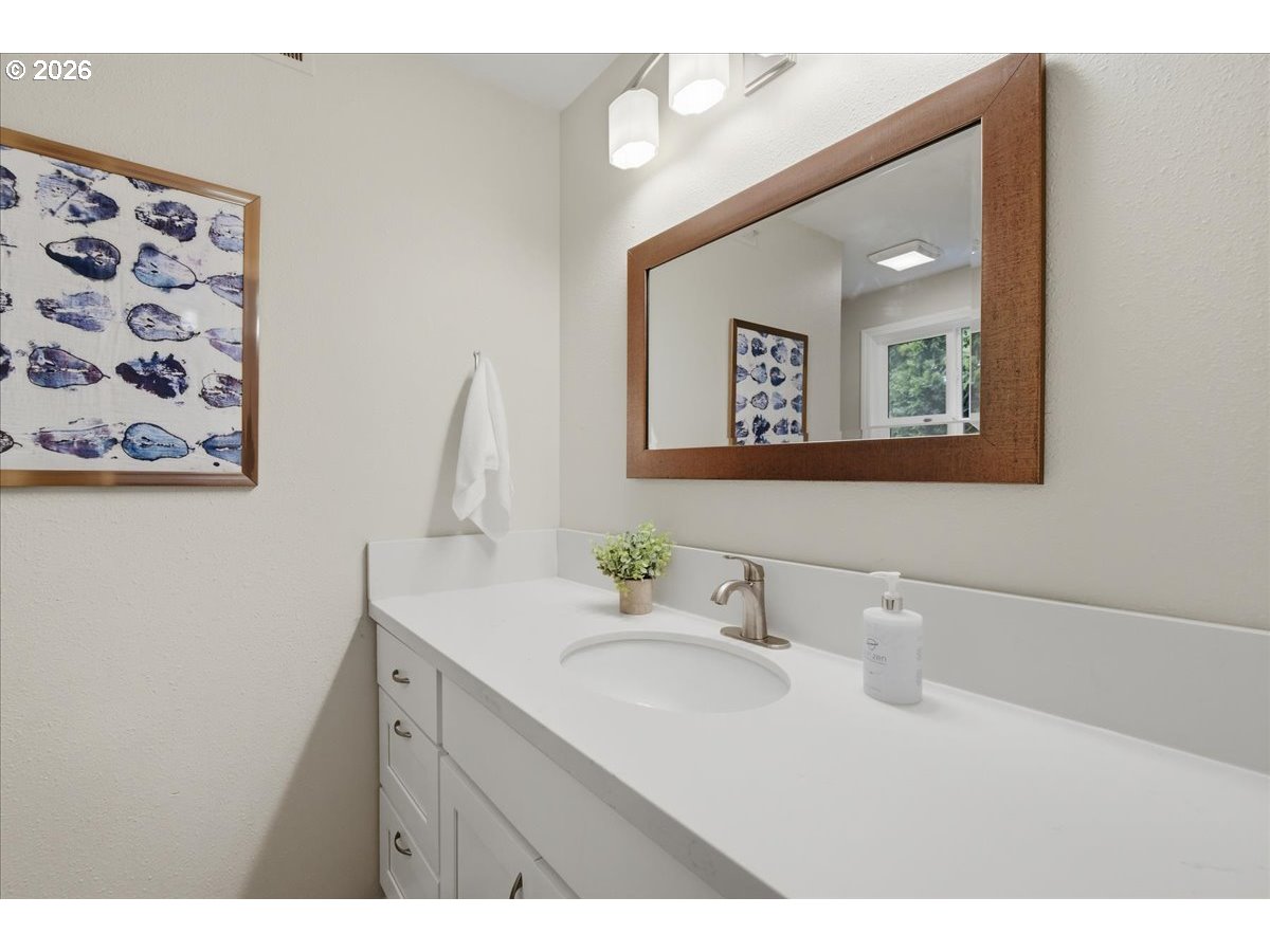 4620 Southwest 183rd Court Beaverton, OR 97078 - Photo 16 of 34 a bathroom with a sink mirror and vanity