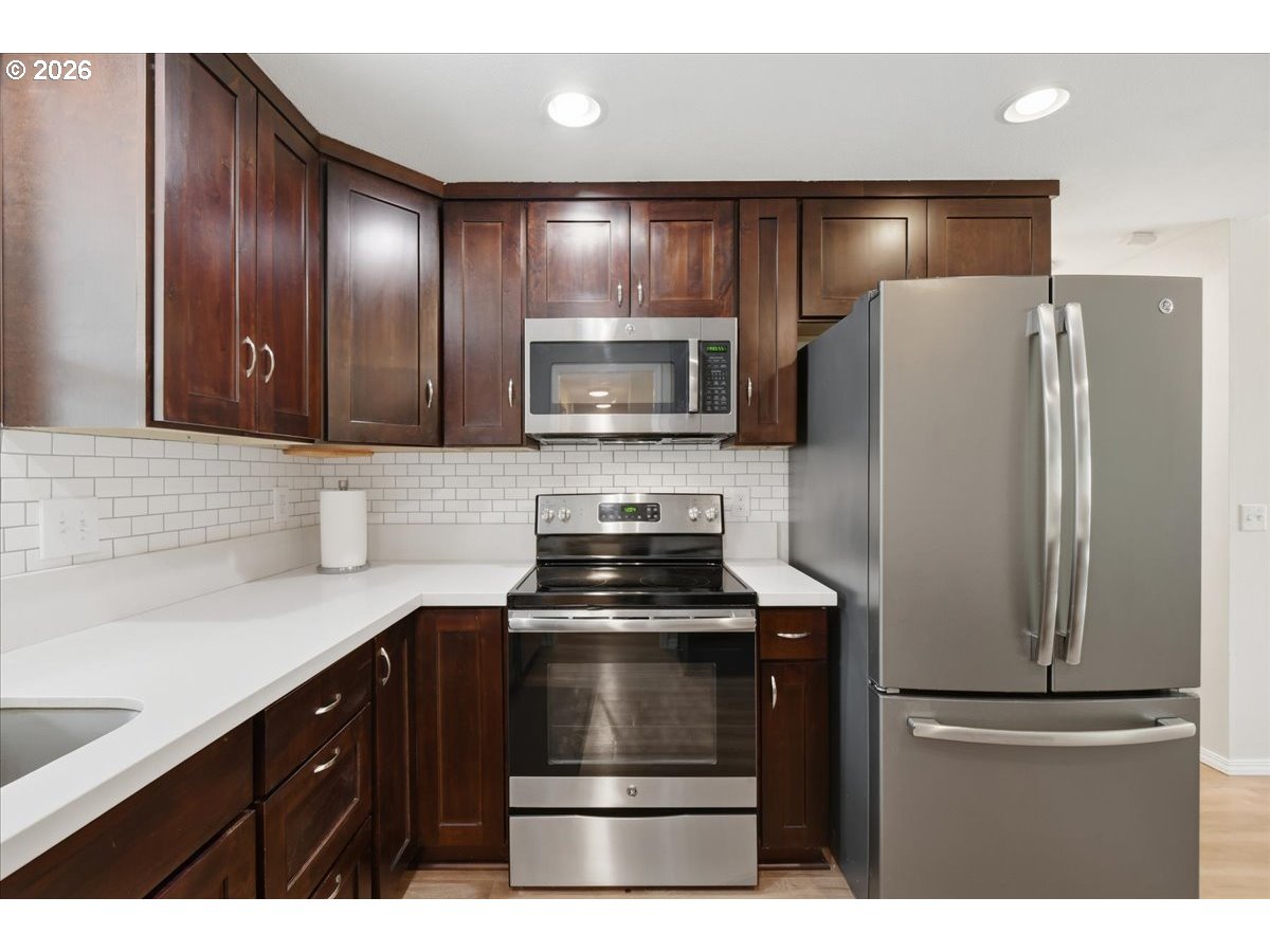 4620 Southwest 183rd Court Beaverton, OR 97078 - Photo 8 of 34 a kitchen with a refrigerator and a sink