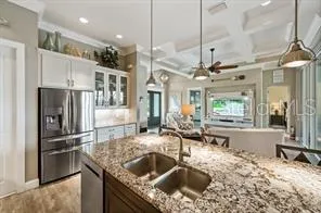 a kitchen with stainless steel appliances granite countertop a sink a stove and a refrigerator