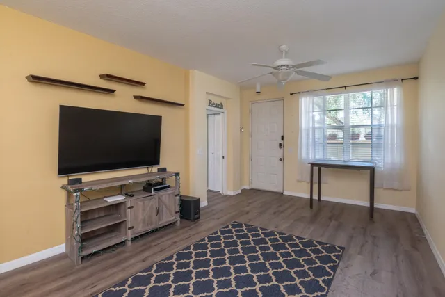 a dining room with furniture and wooden floor