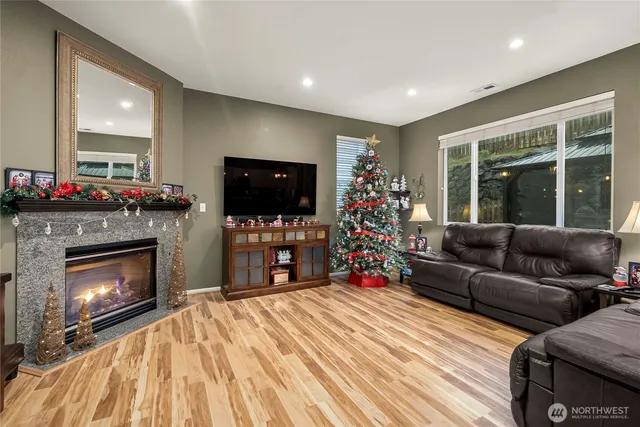 a living room with furniture a flat screen tv and a fireplace