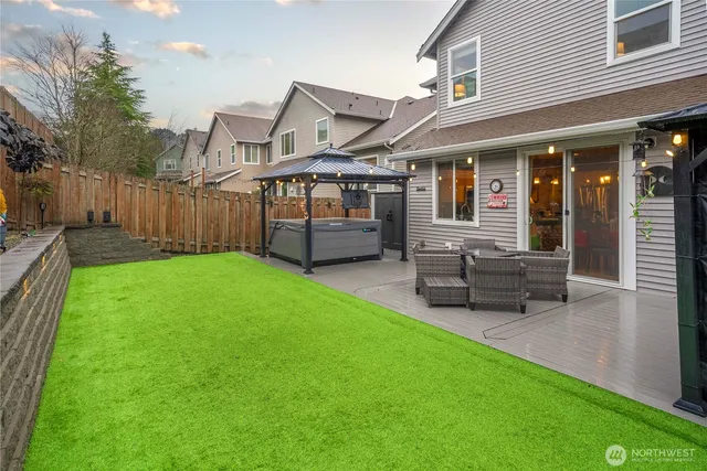 a view of a house with a yard and sitting area