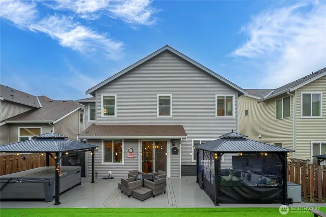 a view of a house with a yard and furniture