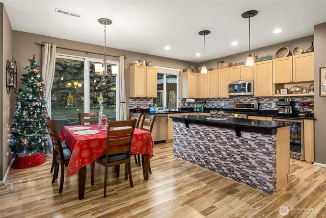 a large kitchen with a table and chairs