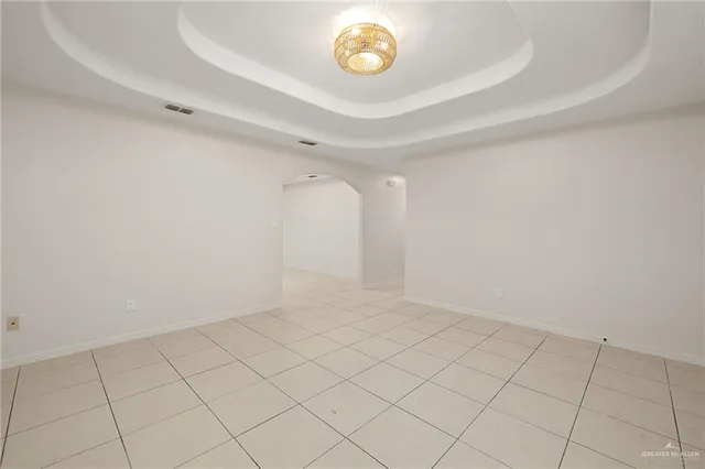 a kitchen with white cabinets a sink stove and refrigerator