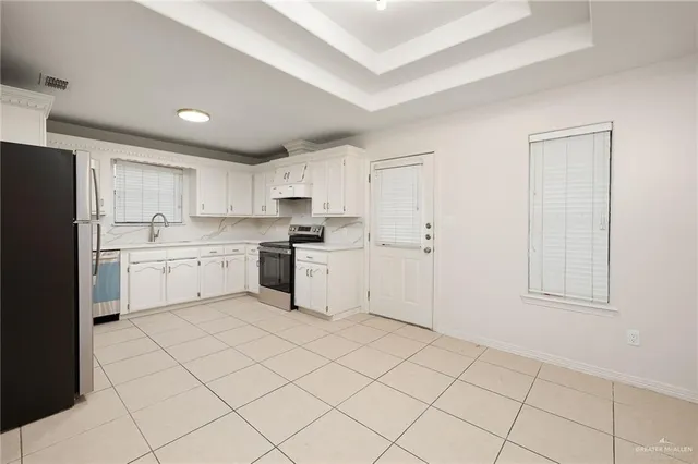 a kitchen with cabinets appliances and a sink