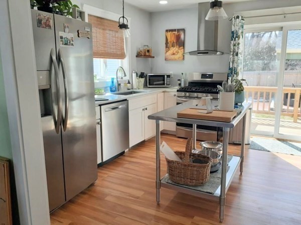 192 Thompson Road Webster, MA 01570 - Photo 4 of 32 a kitchen with stainless steel appliances a refrigerator a sink a stove a dining table and chairs