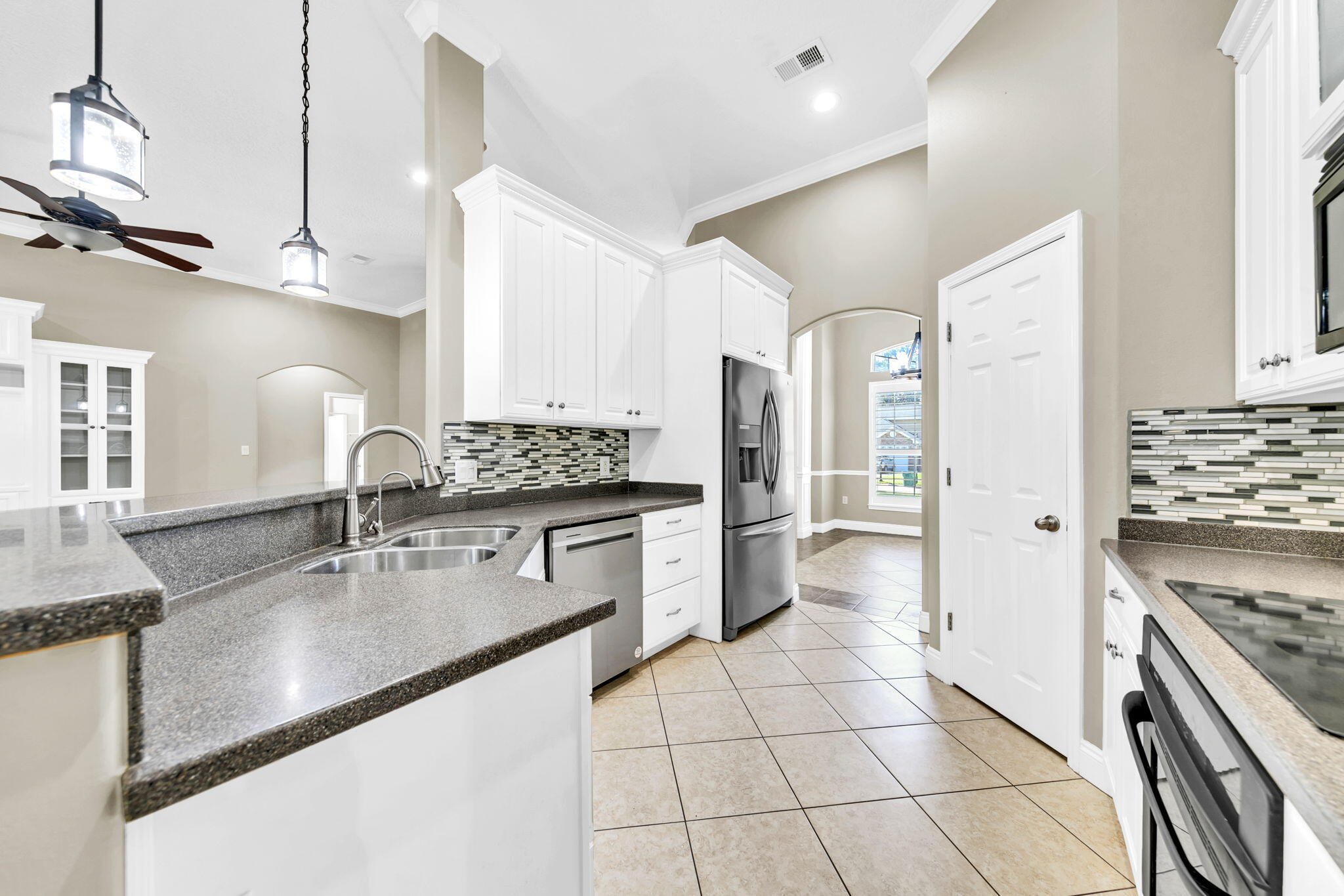 2623 Brodie Lane Crestview, FL 32536 - Photo 7 of 41 a kitchen with stainless steel appliances granite countertop a sink stove and refrigerator