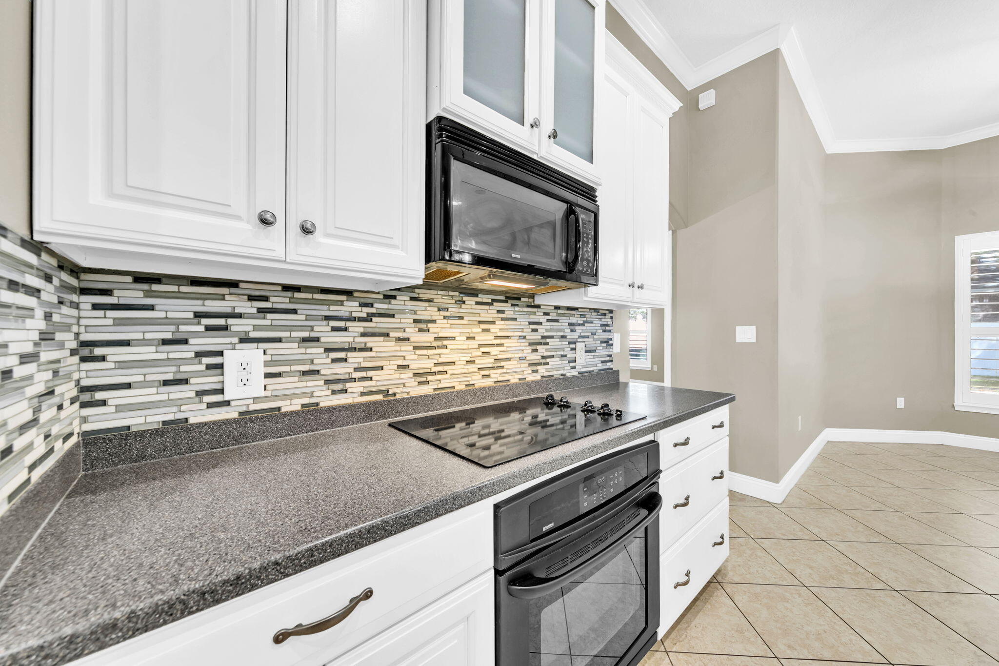 2623 Brodie Lane Crestview, FL 32536 - Photo 9 of 41 a kitchen with stainless steel appliances granite countertop a sink stove and microwave