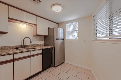 a kitchen with stainless steel appliances granite countertop a sink and a stove