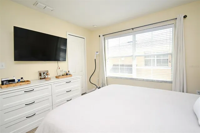 a bedroom with a bed and a flat screen tv