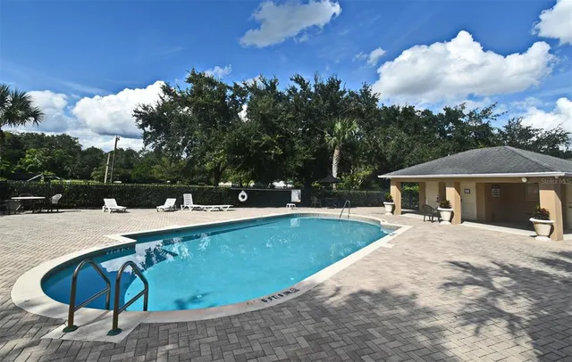 a view of a house with backyard porch and sitting area