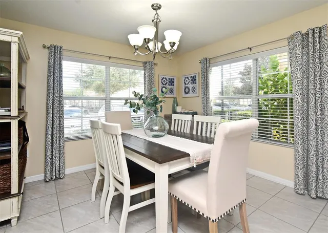 a view of a dining room with furniture wooden floor and chandelier