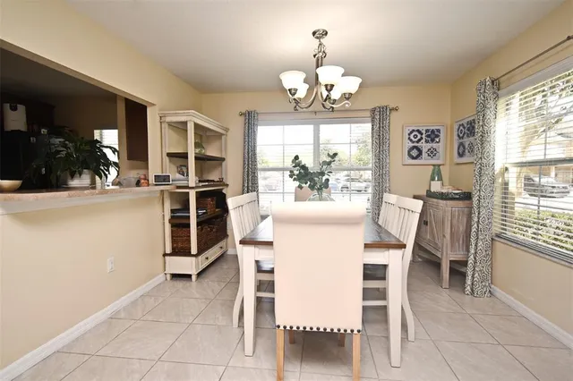 a view of a dining room with furniture and chandelier