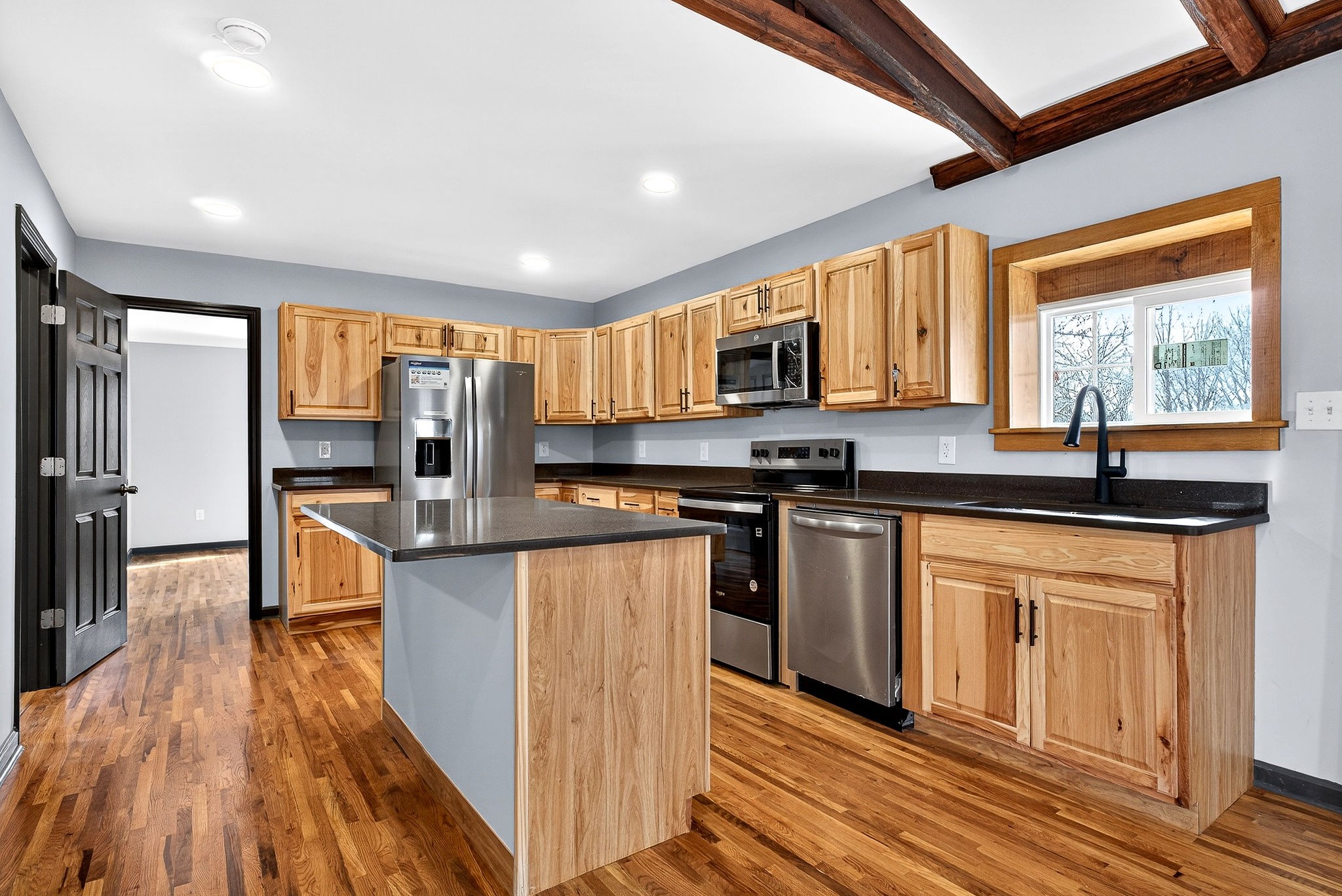 9388 Harrison Ferry Road McMinnville, TN 37110 - Photo 21 of 54 a kitchen with stainless steel appliances granite countertop a stove top oven a sink dishwasher a refrigerator and white cabinets with wooden floor