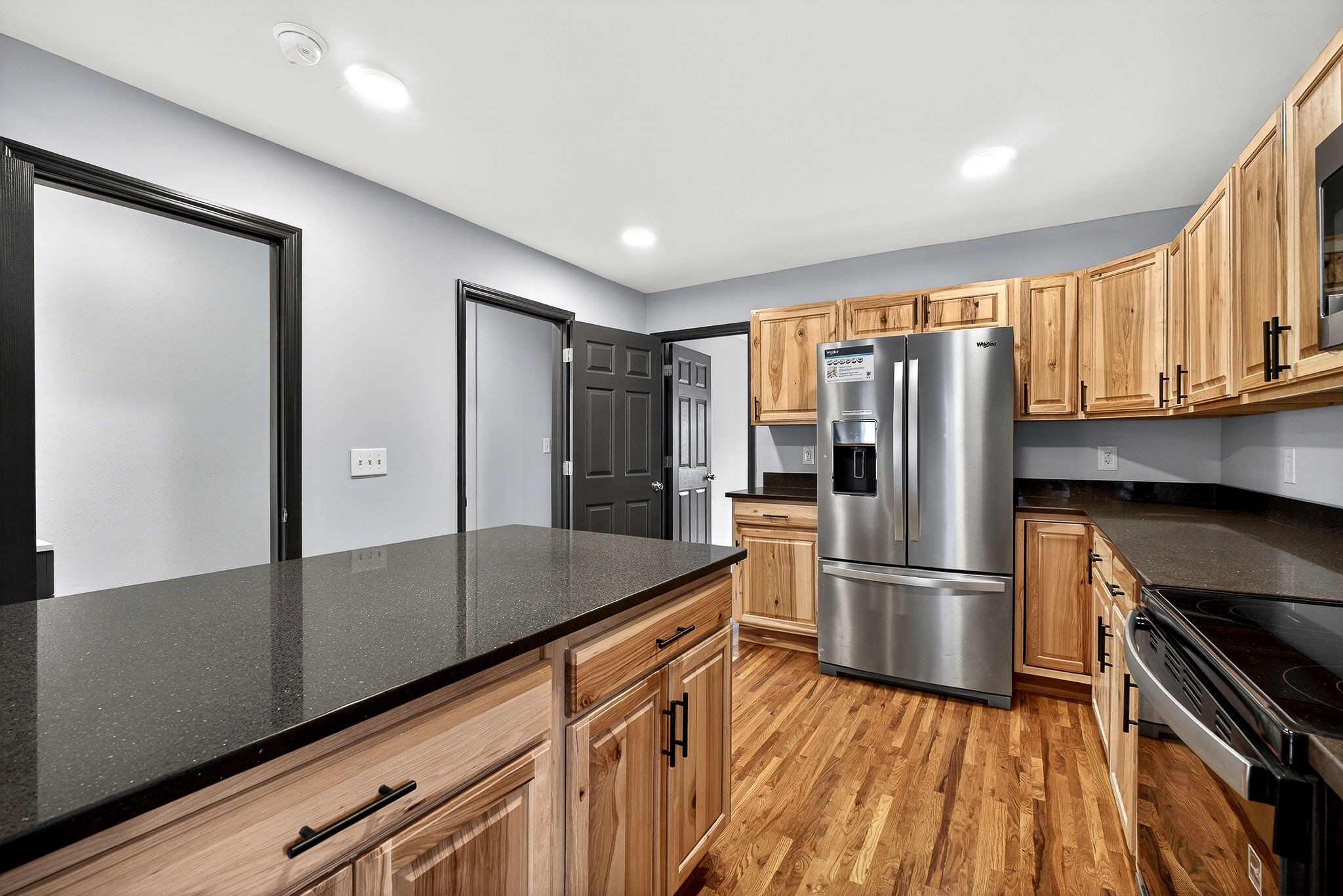 9388 Harrison Ferry Road McMinnville, TN 37110 - Photo 22 of 54 a kitchen with granite countertop a refrigerator and a stove top oven
