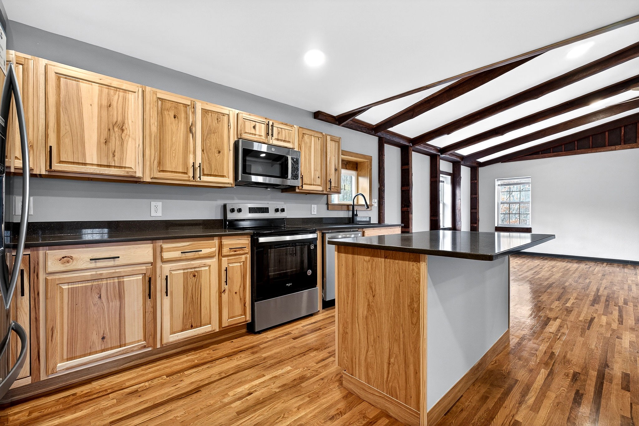 9388 Harrison Ferry Road McMinnville, TN 37110 - Photo 25 of 54 a kitchen with stainless steel appliances granite countertop a stove a sink and a microwave