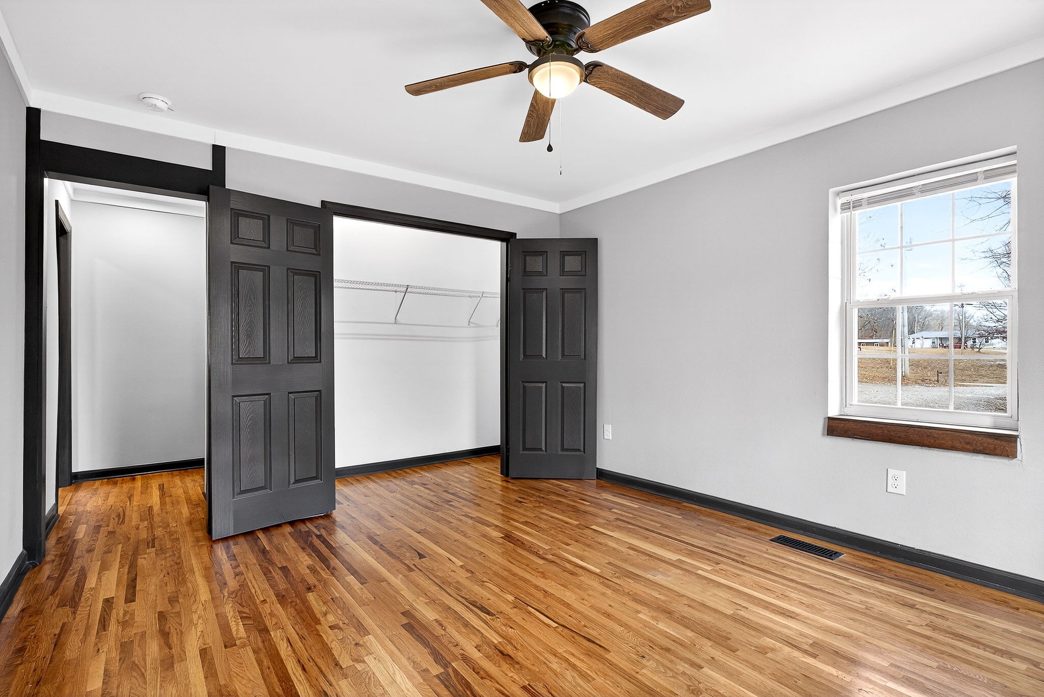 9388 Harrison Ferry Road McMinnville, TN 37110 - Photo 32 of 54 a view of an empty room with wooden floor and a window