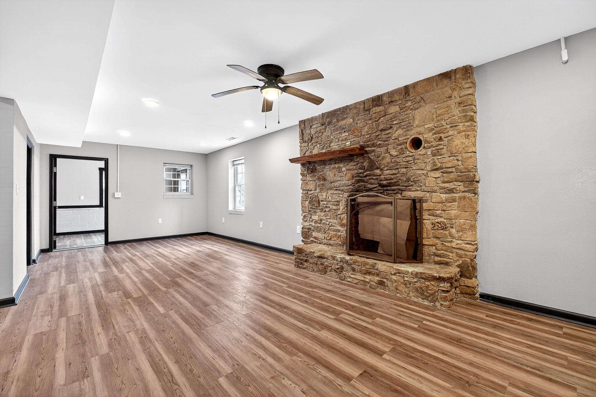 9388 Harrison Ferry Road McMinnville, TN 37110 - Photo 34 of 54 a view of a livingroom with wooden floor a fireplace and window