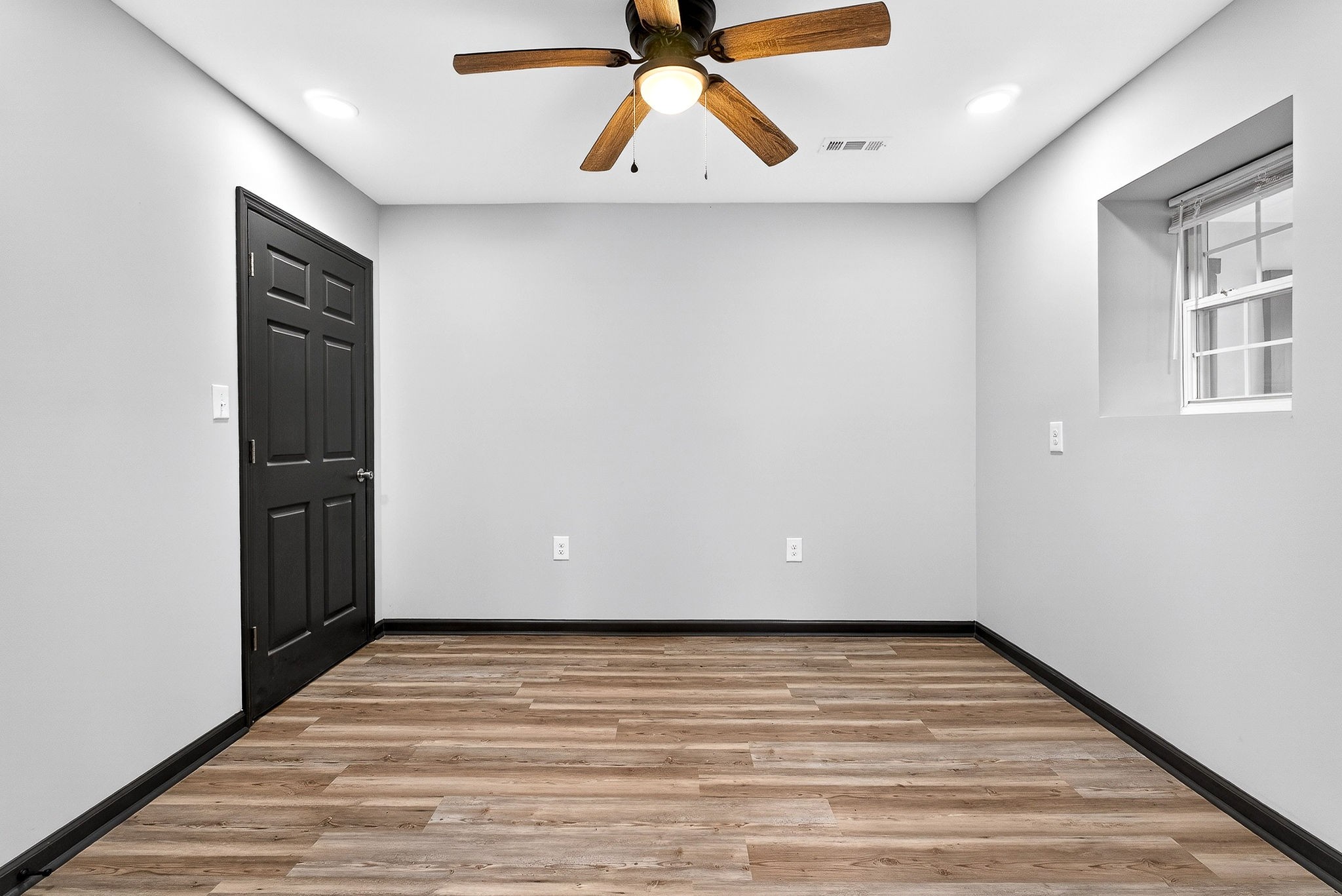 9388 Harrison Ferry Road McMinnville, TN 37110 - Photo 38 of 54 a view of an empty room with wooden floor and a window