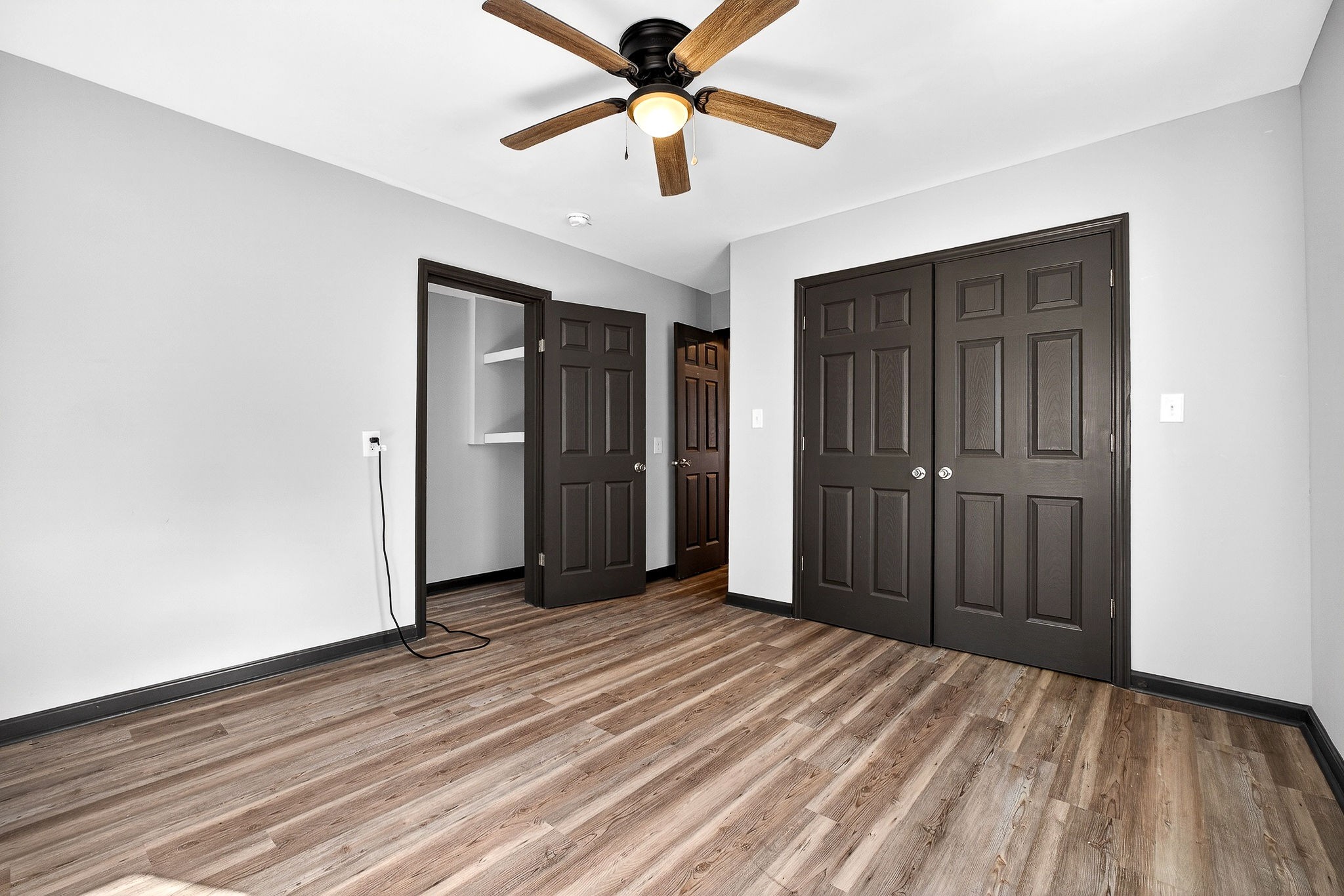9388 Harrison Ferry Road McMinnville, TN 37110 - Photo 40 of 54 an empty room with closet and a ceiling fan