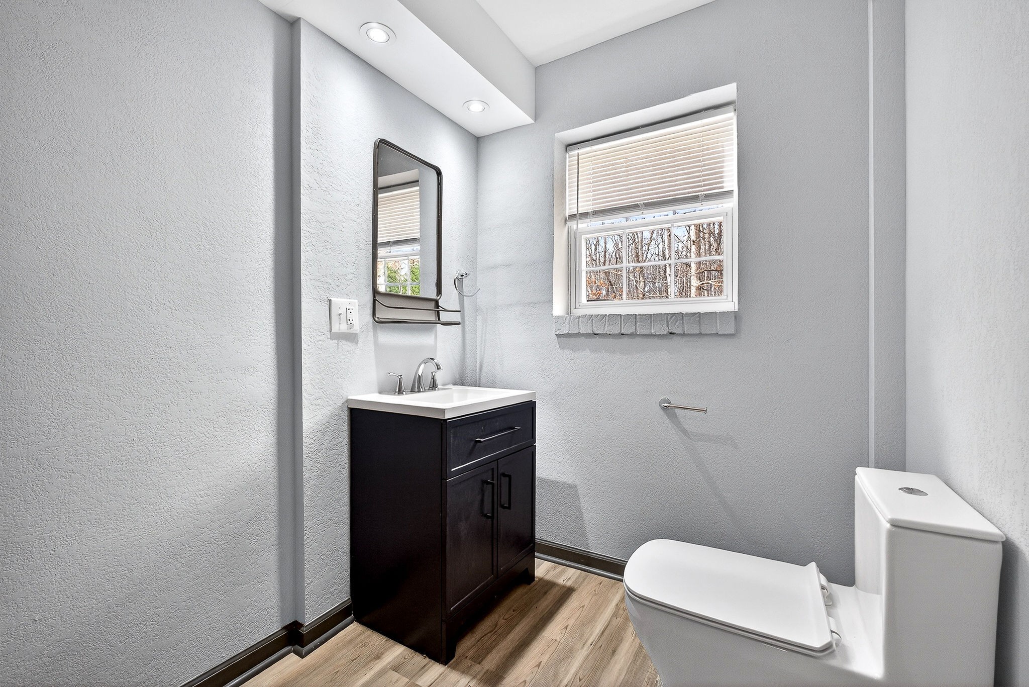 9388 Harrison Ferry Road McMinnville, TN 37110 - Photo 41 of 54 a bathroom with a sink a toilet and mirror
