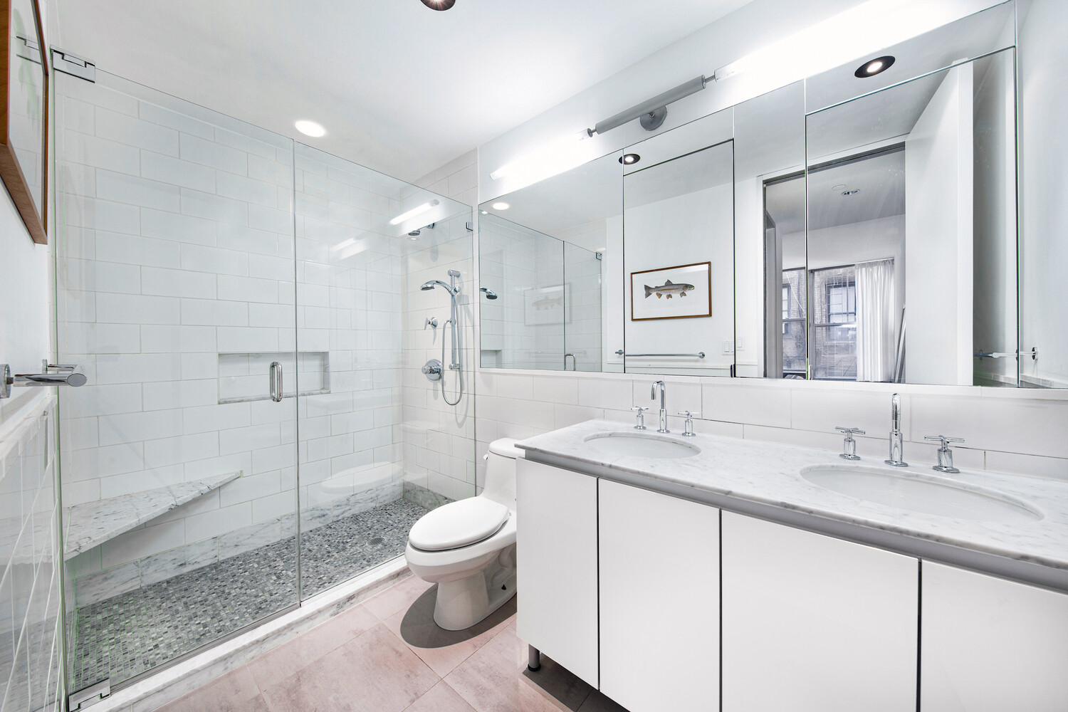 419 West 55th Street, Unit 2D Manhattan, NY 10019 - Photo 6 of 10 a spacious bathroom with a granite countertop sink toilet a mirror and shower