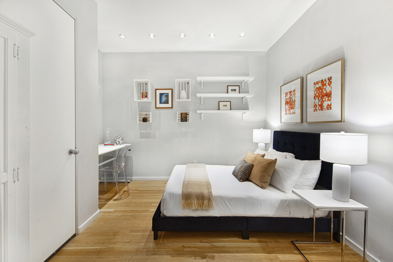 419 West 55th Street, Unit 2D Manhattan, NY 10019 - Photo 7 of 10 a bedroom with a bed and wooden floor