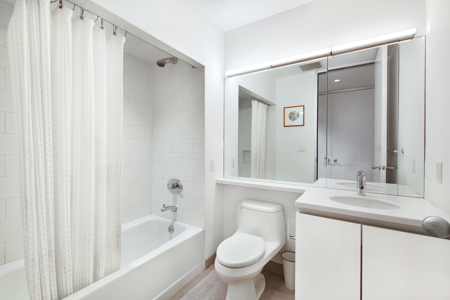419 West 55th Street, Unit 2D Manhattan, NY 10019 - Photo 8 of 10 a bathroom with a granite countertop sink toilet and shower