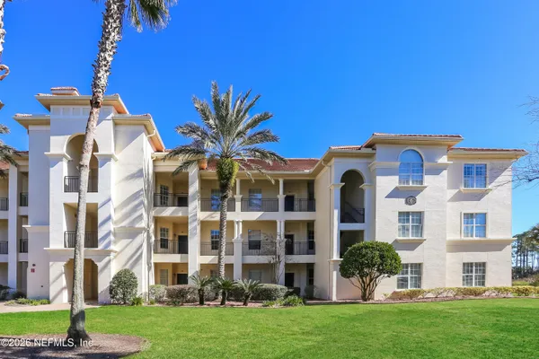 a view of a building with a yard