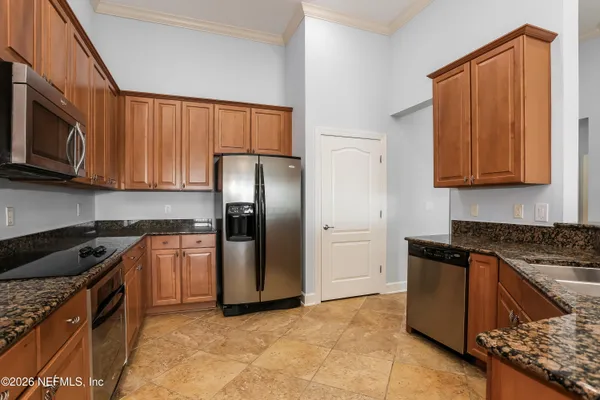 a kitchen with stainless steel appliances granite countertop a sink stove and refrigerator