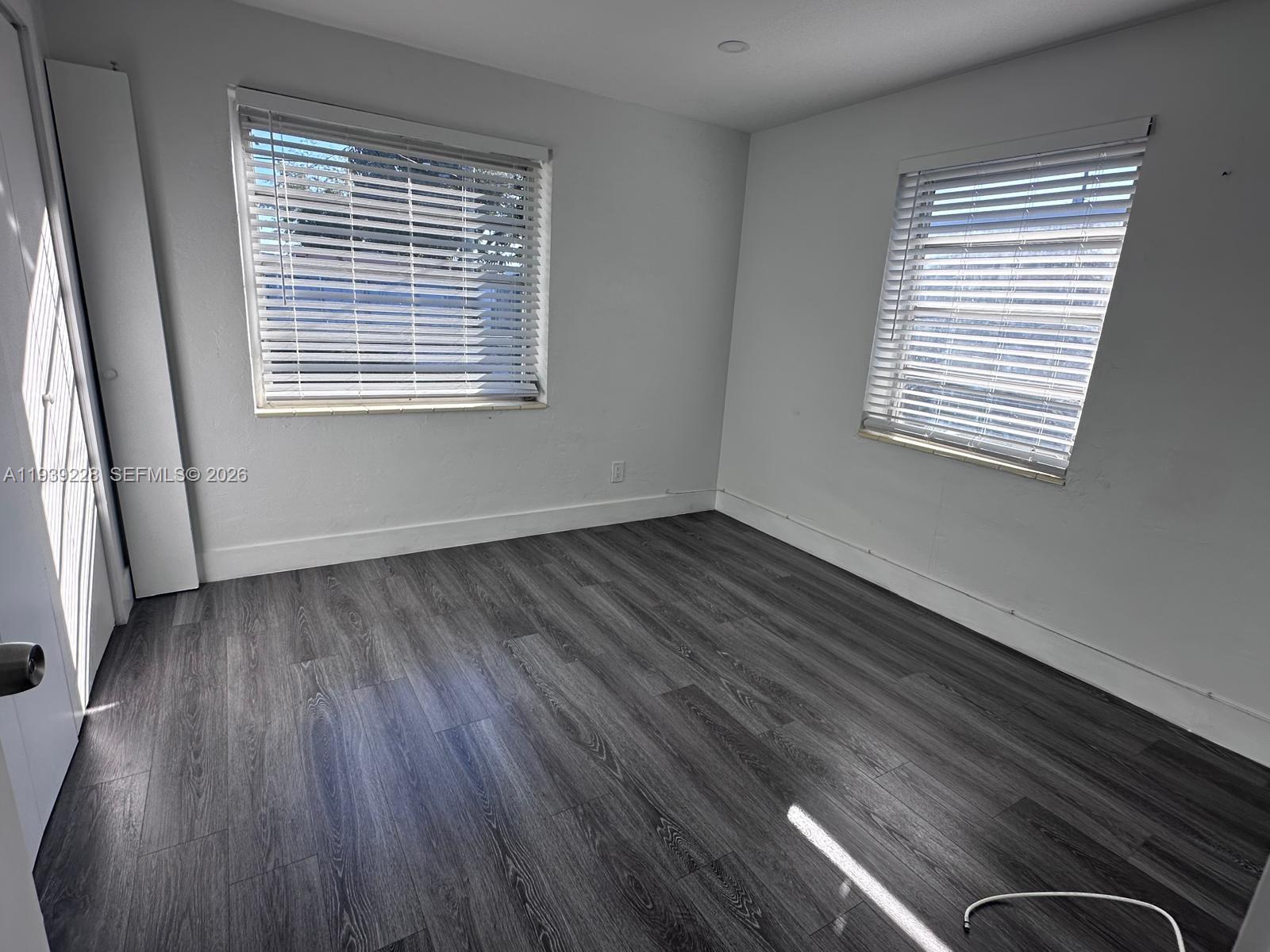650 Southeast 1st Place Hialeah, FL 33010 - Photo 15 of 22 a view of an empty room with wooden floor and a window