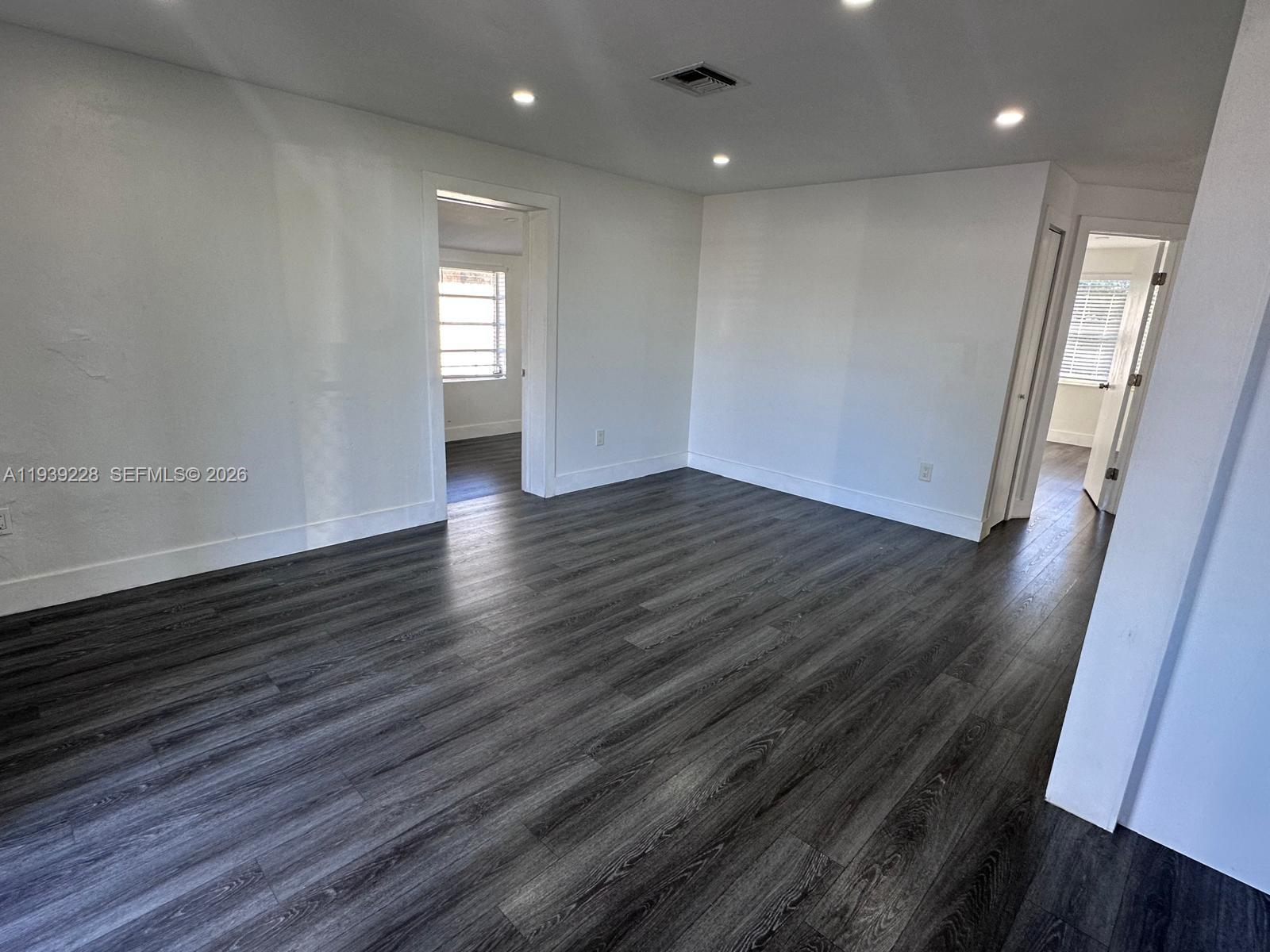650 Southeast 1st Place Hialeah, FL 33010 - Photo 17 of 22 an empty room with wooden floor and window