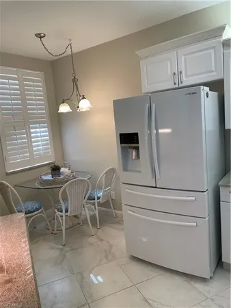 a kitchen with stainless steel appliances granite countertop a sink a stove and a refrigerator
