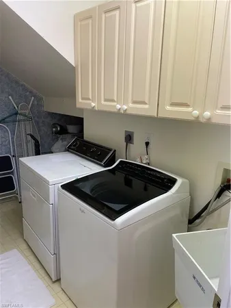 a view of a kitchen that has a sink and cabinets