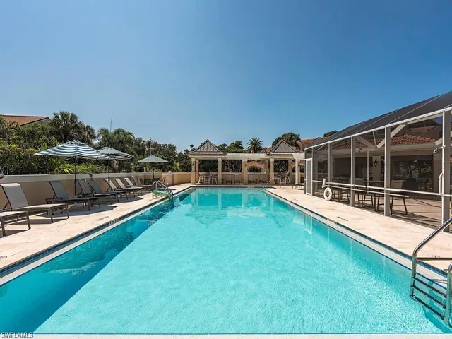 a view of a house with pool and a yard