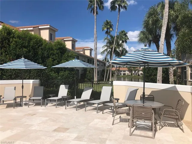 a view of house with yard and sitting area