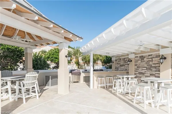a view of a patio with a table and chairs and wooden fence