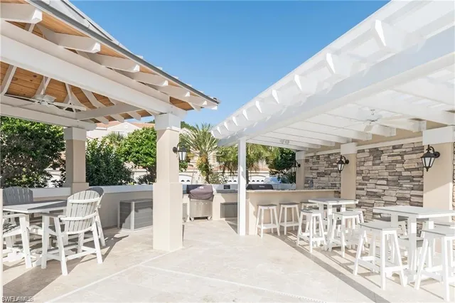 a view of a patio with a table and chairs and wooden fence