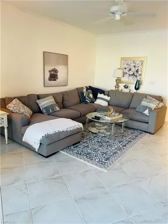 a living room with furniture and painting on the wall