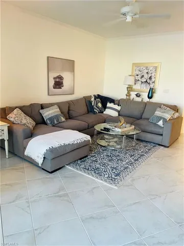 a living room with furniture and painting on the wall