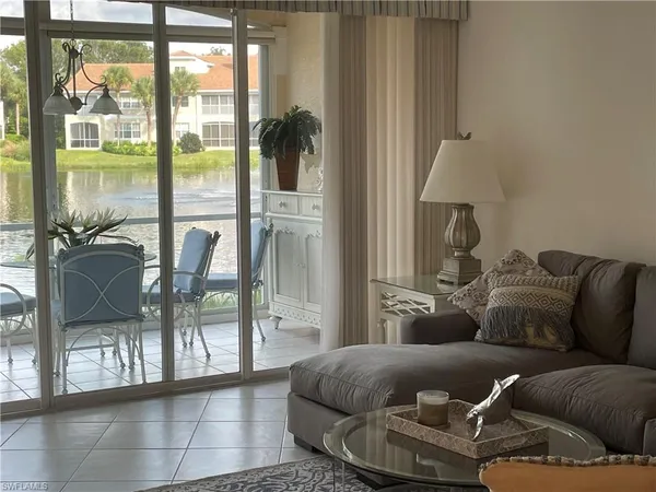 a living room with furniture and a floor to ceiling window
