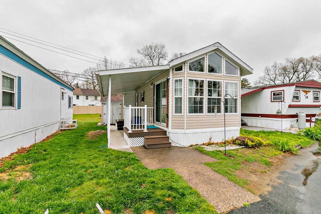 404 Southwick Road, Unit 9 Westfield, MA 01085 - Photo 1 of 30 a front view of a house with garden