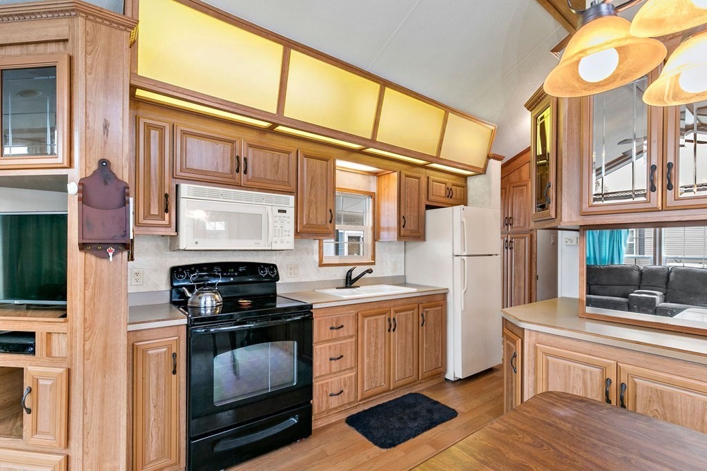 404 Southwick Road, Unit 9 Westfield, MA 01085 - Photo 12 of 30 a kitchen with stainless steel appliances a stove and a refrigerator
