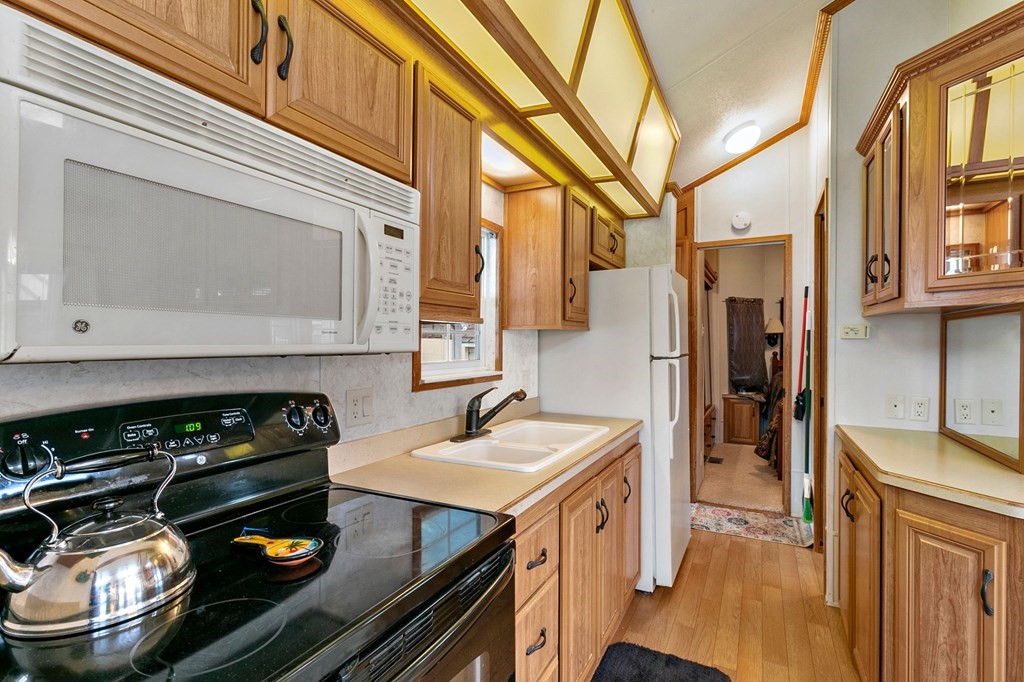 404 Southwick Road, Unit 9 Westfield, MA 01085 - Photo 14 of 30 a kitchen with a stove and a refrigerator