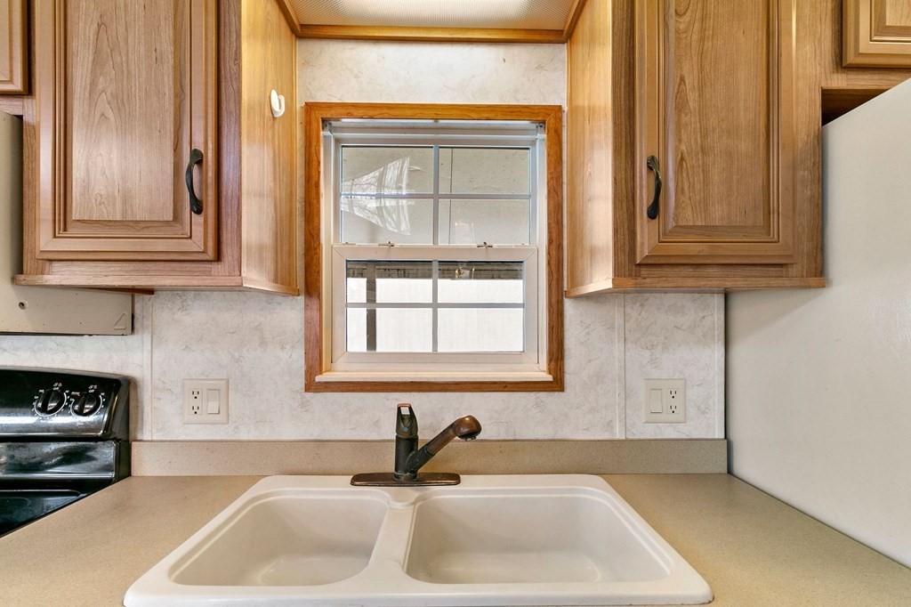 404 Southwick Road, Unit 9 Westfield, MA 01085 - Photo 16 of 30 a kitchen with granite countertop a sink and a window