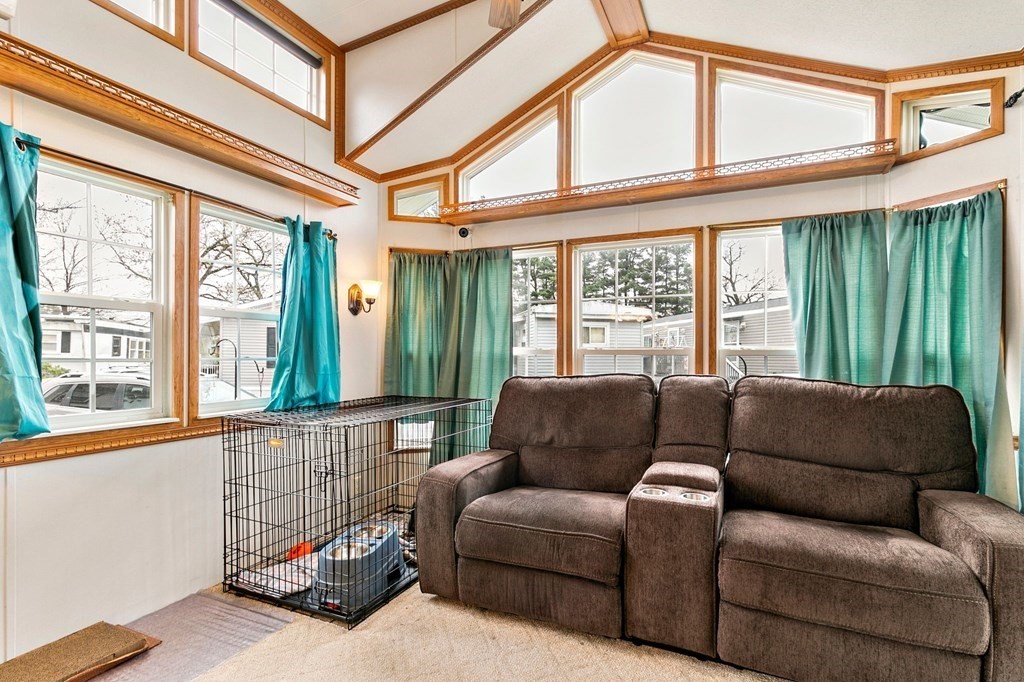 404 Southwick Road, Unit 9 Westfield, MA 01085 - Photo 19 of 30 a living room with furniture a flat screen tv and a large window