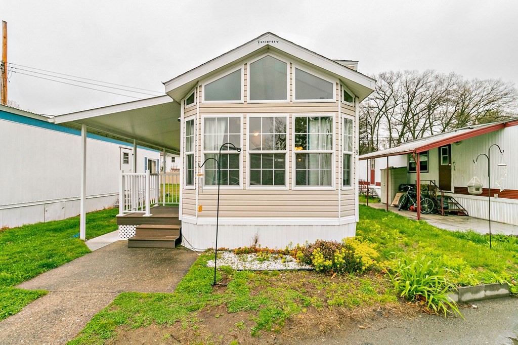 404 Southwick Road, Unit 9 Westfield, MA 01085 - Photo 2 of 30 a front view of a house with garden
